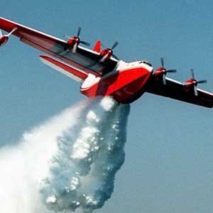 FILE--A Martin Mars flying boat water bomber makes a demonstration drop of some 7,200 gallons of water off the shore of Long Beach, Calif., in this Thursday, June 18, 1998 file photo. Even without a formal request for Canadian help in fighting California's wildfires, the world's largest water bomber will soon be winging its way south while authorities in B.C. are scrambling to see what assets are available if such a call comes in. THE CANADIAN PRESS/AP/Reed Saxon
