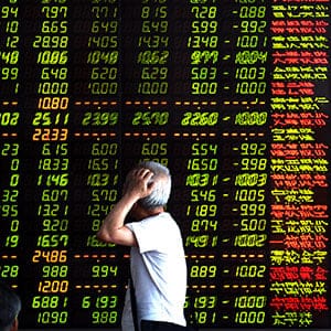 SHENYANG, July 7, 2015-- An investor looks through stock information at a trading hall in a securities firm in Shenyang, northeast China's Liaoning Province, July 7, 2015. Chinese shares lost to negative territory on Tuesday, with the benchmark Shanghai Composite Index down 1.29 percent to finish at 3,727.13 points. The Shenzhen Component Index slumped 5.8 percent to close at 11,375.6 points.  Xinhua News Agency/Getty Images