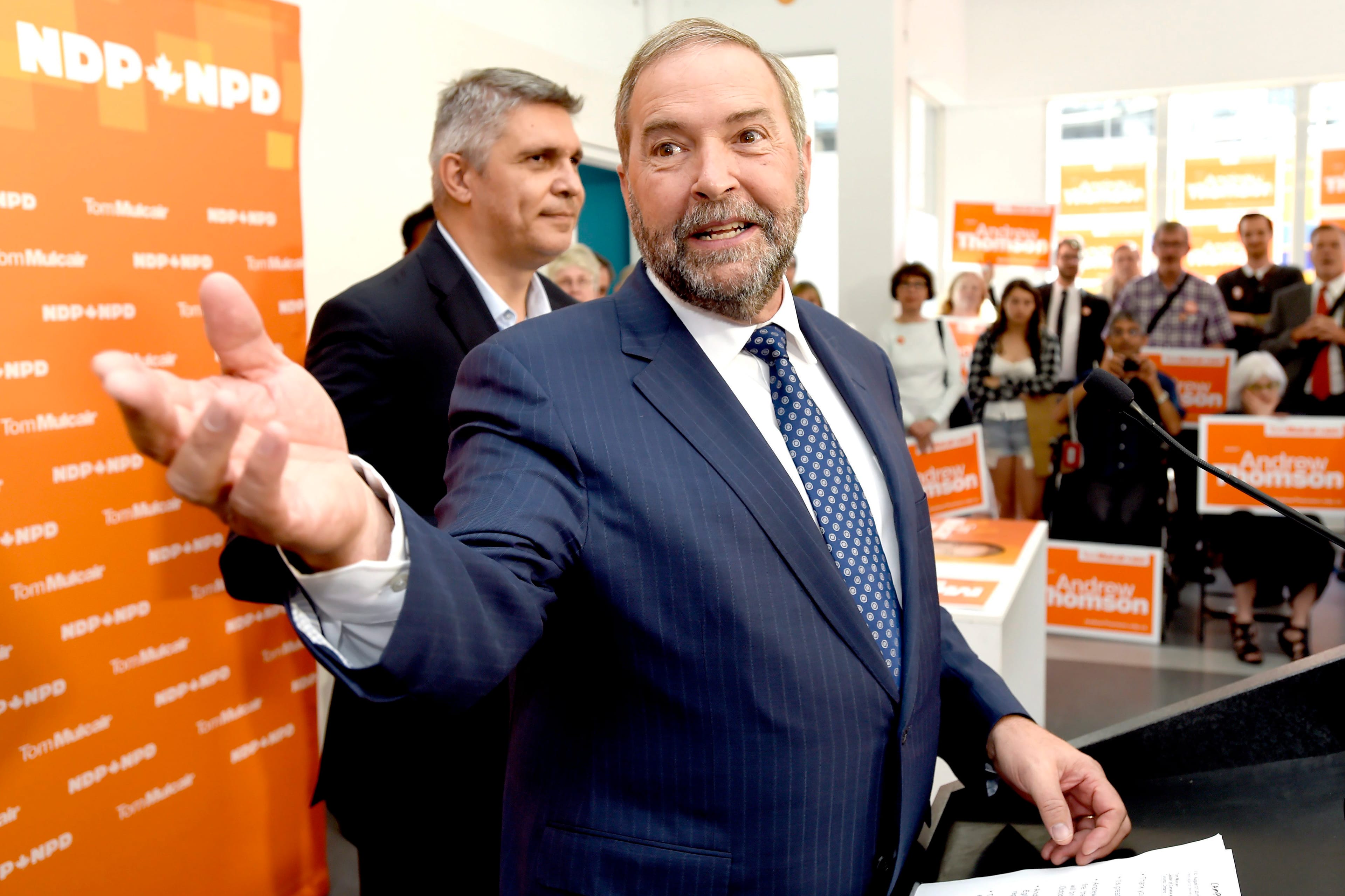 NDP Leader Tom Mulcair speaks to supporters along with candidate Andrew Thomson, left, during a campaign stop in Toronto on Thursday, August 27, 2015. (Frank Gunn/CP)