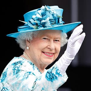 BARKING, UNITED KINGDOM - JULY 16: (EMBARGOED FOR PUBLICATION IN UK NEWSPAPERS UNTIL 48 HOURS AFTER CREATE DATE AND TIME) Queen Elizabeth II waves from the balcony of the Broadway Theatre during a day of engagements in the London Borough of Barking and Dagenham on July 16, 2015 in Barking, England. (Max Mumby/Indigo/Getty Images)