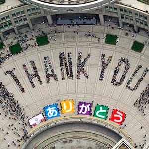 An aerial view shows people sitting in formation to the words "thank you" and displaying signs that collectively read "Arigato" (Thank You) during an event celebrating Tokyo being chosen to host the 2020 Olympic Games, at Tokyo Metropolitan Government Building in Tokyo, in this photo taken by Kyodo September 8, 2013. Tokyo was awarded the 2020 summer Olympic Games on Saturday, beating Istanbul in a head-to-head vote after Japanese Prime Minister Shinzo Abe delivered a charismatic plea to the International Olympic Committee and promised Japan's crippled nuclear plant was "under control." (Kyodo/Reuters)    

 (JAPAN - Tags: SPORT OLYMPICS POLITICS) ATTENTION EDITORS - THIS IMAGE HAS BEEN SUPPLIED BY A THIRD PARTY. IT IS DISTRIBUTED, EXACTLY AS RECEIVED BY REUTERS, AS A SERVICE TO CLIENTS. FOR EDITORIAL USE ONLY. NOT FOR SALE FOR MARKETING OR ADVERTISING CAMPAIGNS. MANDATORY CREDIT. JAPAN OUT. NO COMMERCIAL OR EDITORIAL SALES IN JAPAN - RTX13CKF
