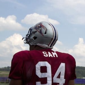 Michael Sam (L), newly signed defensive end for the Montreal Alouettes CFL football team arrives on the field for rookie training camp in Sherbrooke, Quebec May 27, 2015.  REUTERS/Christinne Muschi  - RTX1EU5A