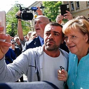 A migrant takes a selfie with German Chancellor Angela Merkel outside a refugee camp near the Federal Office for Migration and Refugees after registration at Berlin's Spandau district, Germany September 10, 2015. (Fabrizio Bensch/Reuters)