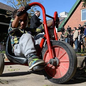 Youngsters play as NDP leader Thomas Mulcair holds a press conference at a daycare in Ottawa on Tuesday, October 14, 2014. The New Democrats are proposing a national child-care program that would cost no more than $15 a day per child. (Sean Kilpatrick/CP)