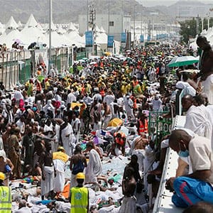 Muslim pilgrims and rescuers gather around the victims of a stampede in Mina, Saudi Arabia during the annual hajj pilgrimage on Thursday, Sept. 24, 2015. Hundreds were killed and injured, Saudi authorities said. The crush happened in Mina, a large valley about five kilometers (three miles) from the holy city of Mecca that has been the site of hajj stampedes in years past. (AP/CP)