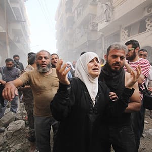 ALEPPO, SYRIA - SEPTEMBER 20 :  Syrian people carry wounded ones to hospital after Assad Regime Forces stage an airstrike to opposition controlled Muvasalat district of Aleppo, Syria on September 20, 2015. (Mamun Ebu Omer/Anadolu Agency/Getty Images)