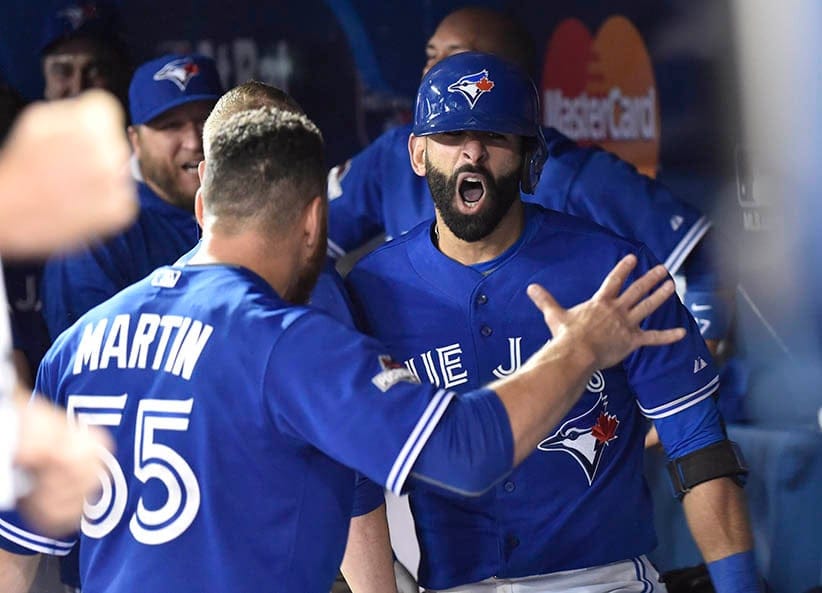 Toronto Blue Jays Jose Bautista celebrates his three-run homer with teammate Russell Martin during seventh inning game 5 American League Division Series baseball action in Toronto on Wednesday, Oct. 14, 2015. (Nathan Denette/CP)