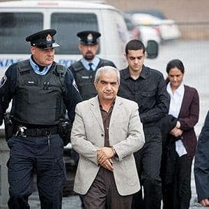 KINGSTON, ON. DECEMBER 5, 2011-- Mohammad Shafia (l), eldest son Hamed Shafia and Tooba Mohammad Yahya ( back)  exit a police van and are escorted to the Kingston Courthouse on Monday December 5, 2011. He along with his dad and mother  are accused of killing the teenage Shafia sisters and Shafia's first wife in a polygamous marriage over family honour.
MACLEAN' S PHOTO BY Vincenzo D'Alto