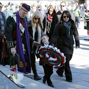 Marcus Cirillo lays a wreath in front of the plaque dedicated to his father after the commemoration ceremony to mark one year since the fatal Oct. 22, 2014 shooting of Cpl. Nathan Cirillo, at the National War Memorial in Ottawa on Oct. 22, 2015. (Photograph by David Kawai)