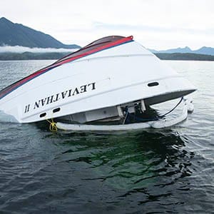 The bow of the Leviathan II, a whale-watching boat owned by Jamie's Whaling Station carrying 24 passengers and three crew members that capsized on Sunday, is seen near Vargas Island Tuesday, October 27, 2015 as it waits to be towed into Tofino, B.C., for inspection. (Photograph by Adam Chilton)