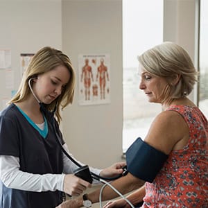 Nurse checking patients blood pressure in examination room. (Hero Images/Getty Images)