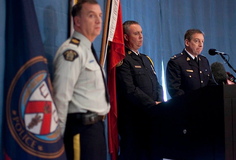 Inspector Keith Finn (right) of the RCMP's  Integrated National Security Enforcement Team (INSET) stands with  Superintendent Tom Fitzgerald (centre) of the Toronto Police Service during a press conference in Toronto on Thursday March 30, 2011 relating to the arrest of Mohamed Hersi.  The 25-year-old Hersi was arrested on Tuesday night just as he was about to board a plane to Cairo, Egypt with the police claiming he was eventually destined for Somalia to allegedly join Al-Shabaab and participate in their terrorist activities. (Chris Young/CP)