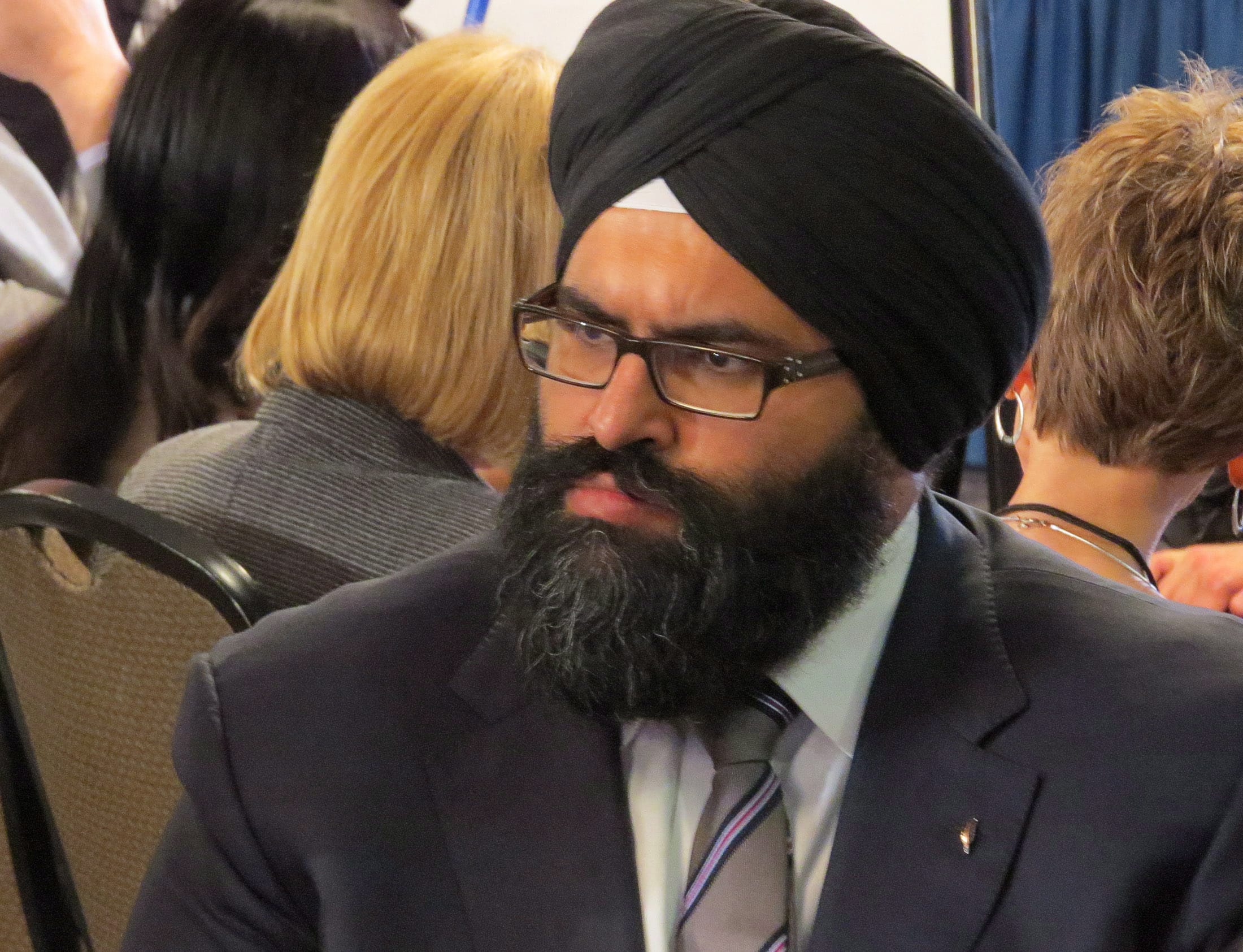 Manmeet Bhullar listens in on group discussions in Edmonton, Wednesday, Jan.29, 2014 around changing provincial privacy laws to allow more information to be published on the deaths of children in government care. (Dean Bennett/CP)