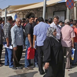 Syrian refugees gather outside their embassy waiting to apply for passports or to renew their old passports, in Amman, Jordan, Sept.15, 2015. Somewhere right now, in a refugee camp in Amman or a rental apartment in Beirut or on a street in Istanbul, sits a Syrian hoping to be among the 25,000 people resettled to Canada, possibly by the end of the year.THE CANADIAN PRESS/ AP/Raad Adayleh