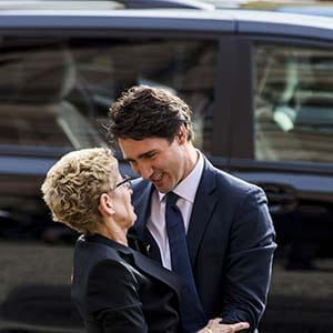 Canada's Prime Minister designate Justin Trudeau (R) greets Ontario Premier Kathleen Wynne as they are surrounded by security detial at Queen's Park in Toronto, October 27, 2015. (Mark Blinch/Reuters)