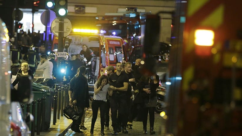 French security moves people in the area of Rue Bichat in the 10th arrondissement of the French capital Paris following a string of attacks on November 13, 2015. At least 18 people were killed as multiple shootings and explosions hit Paris, police said. Police also said there was an ongoing hostage crisis in the Bataclan a concert hall in the French capital. (KENZO TRIBOUILLARD/AFP/Getty Images)