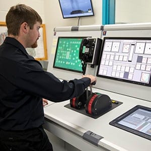 Liam Burke working in the Marine Engineering Simulation room at Nova Scotia Community College Strait Area campus in Port Hawkesbury, Nova Scotia, September 25, 2015. (Photograph by Kayla Chobotiuk)