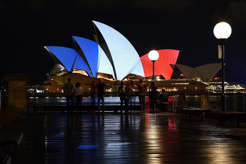 epa05024432 The Sydney Opera House is illuminated in the French national colours in tribute for the victims of the 13 November Paris attacks, in Sydney, Australia, 14 November 2015. At least 120 people have been killed in a series of attacks in Paris on 13 November, according to French officials. Eight assailants were killed, seven when they detonated their explosive belts, and one when he was shot by officers, police said.  (DAN HIMBRECHTS/EPA/CP)