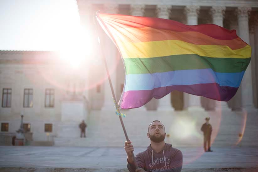 WASHINGTON, DC - APRIL 28: Same-sex marriage supporter Vin Testa, of Washington, DC, waves a rainbow pride flag near the Supreme Court, April 28, 2015 in Washington, DC. On Tuesday the Supreme Court will hear arguments concerning whether same-sex marriage is a constitutional right, with decisions expected in June. (Drew Angerer/Getty Images)