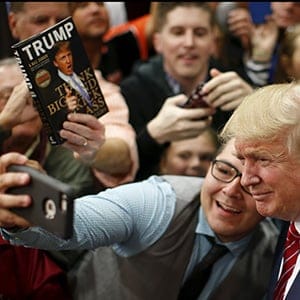 U.S. Republican presidential candidate Donald Trump takes a selfie with a supporter as he prepares to leave a campaign event in Anderson, South Carolina October 19, 2015. (Chris Keane/Reuters)