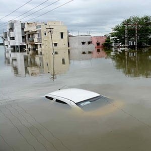 A car is submerged amidst water-logged houses in a rain-hit area of Chennai on November 17, 2015.   India has deployed the army and air force to rescue flood-hit residents in the southern state of Tamil Nadu, where at least 71 people have died in around a week of torrential rains.  (STR/AFP/Getty Images)