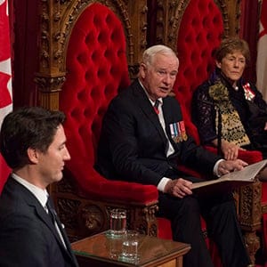 Prime Minister Justin Trudeau and Sharon Johnston listen as Governor General David Johnston delivers the speech from the throne in the Senate Chamber on Parliament Hill in Ottawa, Friday December 4, 2015. THE CANADIAN PRESS/Sean Kilpatrick