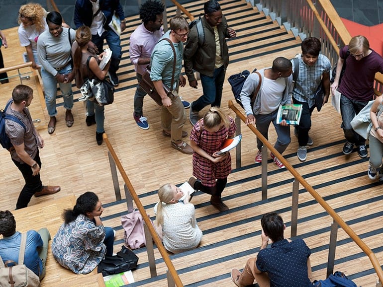Elevated view of university students walking up and down stairs. (David Schaffer/Getty Images)