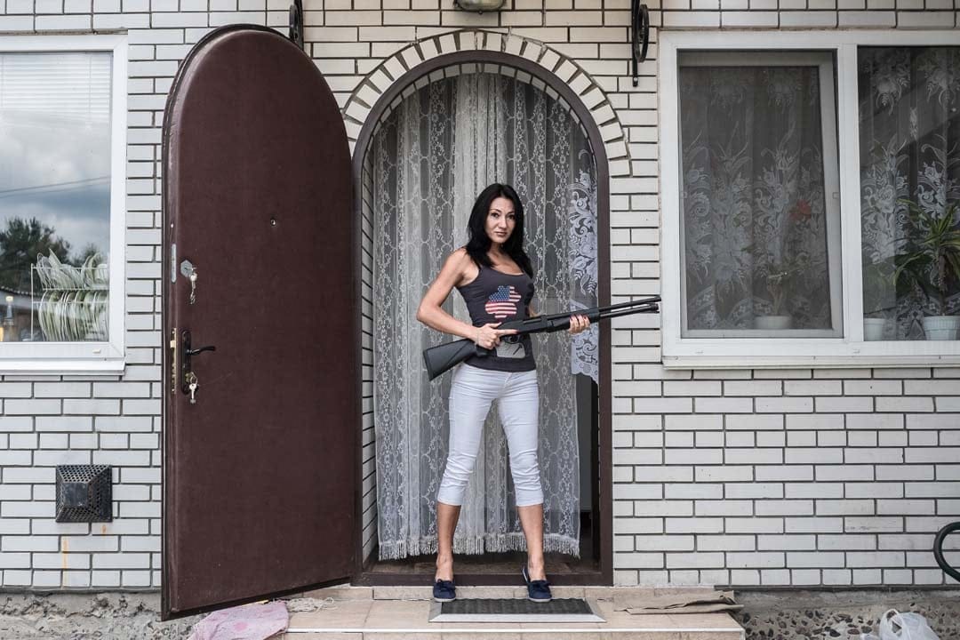 “I think everyone has the right for protection of himself, family and belongings. But every owner should perfectly master his weapon, security rules and clearly understand when to use it. Especially when there’s a shotgun in your hands.”
Elena, 37 years old, marketing expert , in her house near Kiev with shotgun, which she bought in 2014 to protect her family. (Andrey Lomakin)