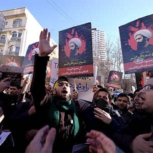 Iranian protesters chant slogans as they hold pictures of Shi'ite cleric Sheikh Nimr al-Nimr during a demonstration against the execution of Nimr in Saudi Arabia, outside the Saudi Arabian Embassy in Tehran January, 3, 2016. (Raheb Homavandi/Reuters)
