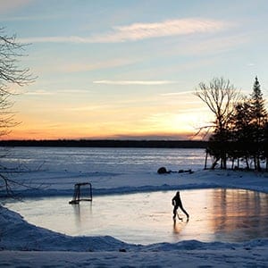 A youth plays pond hockey as the sun rises on Pigeon Lake in the region of Kawartha Lakes Ontario February 4, 2015. (Fred Thornhill/Reuters)