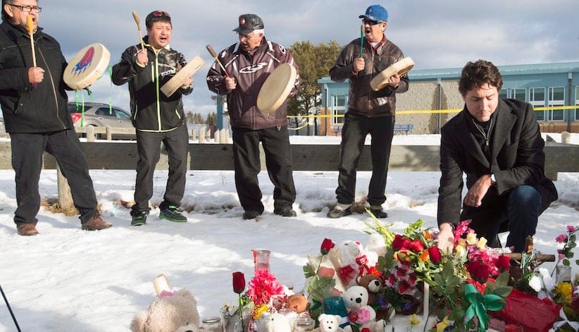 Prime Minister Justin Trudeau pauses for a moment as he lays a wreath outside the La Loche Community school in La Loche, Sask., Friday, Jan. 259, 2016. A 17-year-old boy allegedly shot two people at the school last Friday after shooting two brothers to death earlier at a home nearby. THE CANADIAN PRESS/Jonathan Hayward