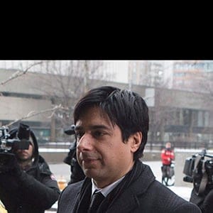 Former CBC radio host Jian Ghomeshi walks past protesters as he arrives at a Toronto court for day six of his trial on Tuesday, Feb. 9, 2016. THE CANADIAN PRESS/Chris Young