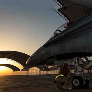 An aircraft technician from Air Task Force – Iraq inspects the nose landing gear of a CF-188 Hornet aircraft at the Camp Patrice Vincent flight line, in Kuwait during Operation IMPACT on December 11, 2015. (Canadian Forces Combat Camera)