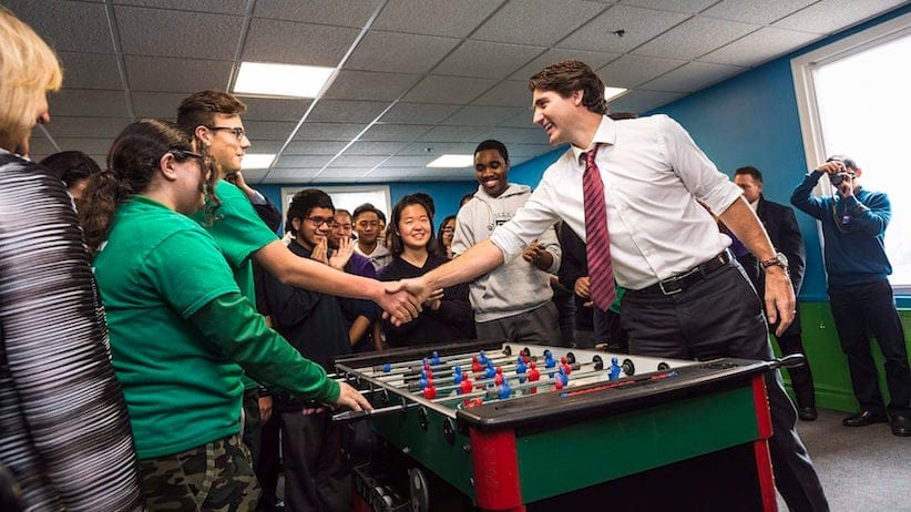 On the 100 day anniversary of his time in office, Prime Minister Justin Trudeau plays foosball with local youth at the Dovercourt Boys and Girls Club before making an announcement to the media about the expansion of the Canada Summer Jobs Program in Toronto on Friday, February 12, 2016. THE CANADIAN PRESS/Aaron Vincent Elkaim