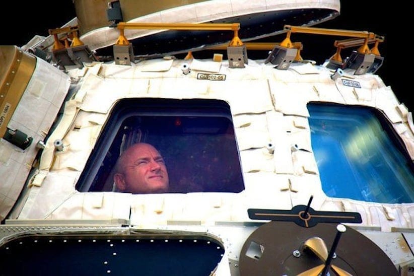 In this undated photo provided by NASA on Tuesday, March 1, 2016, astronaut Scott Kelly looks out the cupola of the International Space Station. Kelly closes the door Tuesday to an unprecedented year in space for NASA, flying back to the planet and loved ones he left behind last March. (NASA via AP)