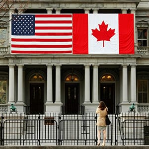 A woman stops to take a photo of the U.S. and Canadian flags placed side-by-side on the Eisenhower Executive Office Building next to the White House in Washington March 8, 2016.  Preparations are under way for the official state visit of Canada's Prime Minister Justin Trudeau on Thursday. (Kevin Lamarque/Reuters)