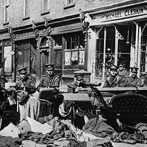 (Original Caption) 5/11/1916 - Dublin, Ireland: Easter Rebellion - Photo shows British troops armed with machine guns and rifles behind a moveable barricade composed of household furniture and which could easily be pushed foreward, in a street in the central section of Dublin. (Bettmann/Getty Images)