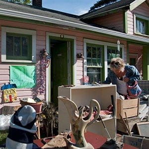 A woman sifts through antiques in the yard of Sue Grude in Irish Hills, Mich. Friday, Aug. 7, 2015, as part of Michigan's Longest Garage Sale stretching 180 miles through the state and lasting all weekend. Jessica Christian/The Jackson Citizen Patriot/CP