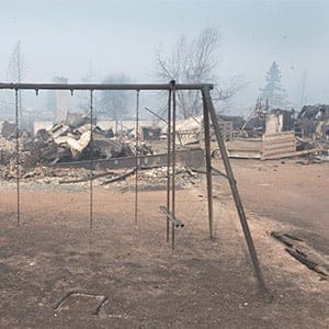 A swing set with the swings burned away sits in a residential neighbourhood destroyed by a wildfire on May 6, 2016 in Fort McMurray, Alberta, Canada Wildfires, which are still burning out of control, have forced the evacuation of more than 80,000 residents from the town.  (Photo by Scott Olson/Getty Images)