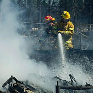 Firefighters work on the smouldering remains of houses in Slave Lake, Alberta, on Monday, May 16, 2011. Whole neighbourhoods were flattened by firestorm that swept through the town of 7,000 destroying upwards of 40% of the buildings. (Ian Jackson/CP)