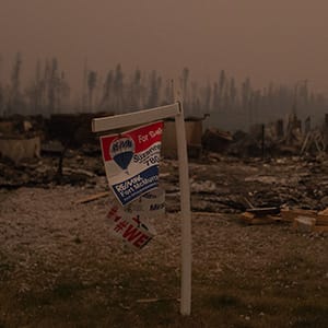 Thick smoke hangs over burnt homes along Prospect Drive in Fort McMurray's Timberlea neighbourhood as wildfires continue to burn out of control in northern Alberta on Sunday, May 15, 2016.  (Photograph by Amber Bracken)