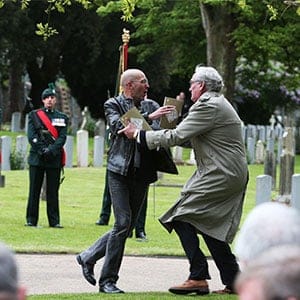 Canadian Ambassador to Ireland Kevin Vickers, right, wrestles with a protester during a State ceremony to remember the British soldiers who died during the Easter Rising at Grangegorman Military Cemetery, Dublin Thursday May 26, 2016.  Vickers helped subdue a demonstrator who began chanting “insult” at the service commemorating more than 100 British soldiers killed trying to suppress the Easter Rising a century ago. (Brian Lawless/AP)