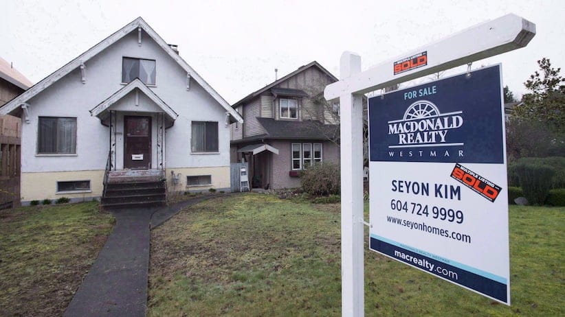 A sold home is pictured in Vancouver, B.C., Thursday, Feb. 11, 2016. Canada Mortgage and Housing Corporation says there is mounting evidence that house prices in a number of Canadian cities are out of whack with incomes and other economic fundamentals.The latest report from CMHC says there is evidence of overvaluation in nine of the 15 real estate markets included in the research. THE CANADIAN PRESS/Jonathan Hayward
