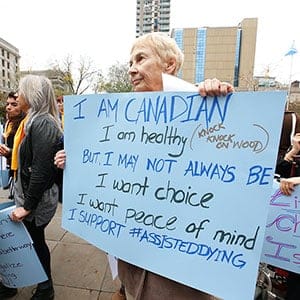 Marlene Cuthbert of Mississauga was at the Toronto rally and voiced her opinion. About 80 supporters of Dying With Dignity showed up outside of the 361 University Ave courthouse as a show of support for doctor assisted deaths - with nine other rallies across the country - coinciding with the hearing at the Supreme Court hearing on the Carter case.  Wednesday October 15, 2014. (Jack Boland/Toronto Sun/Postmedia)