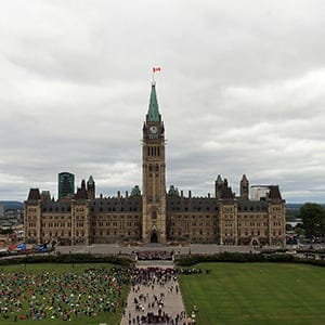 MPs and Senator pose for a group photo on the front steps of Parlaiment in Ottawa. Photo by Dave Chan.