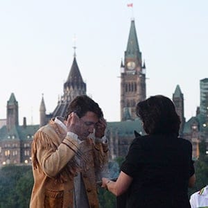Prime Minister Justin Trudeau takes part in the National Aboriginal Day Sunrise Ceremony on the banks of the Ottawa River in Gatineau, Que., on Tuesday, June 21, 2016. The Canadian Parliament building in Ottawa are seen in the background. (Sean Kilpatrick/CP)