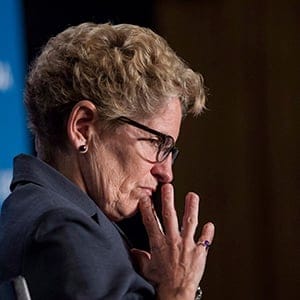 Ontario Premier Kathleen Wynne listens to remarks from Manitoba Premier Greg Selinger (not shown) at the opening of the Building Canada Up Summit in Toronto on Wednesday August 6, 2014. (Chris Young/CP)