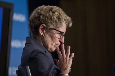 Ontario Premier Kathleen Wynne listens to remarks from Manitoba Premier Greg Selinger (not shown) at the opening of the Building Canada Up Summit in Toronto on Wednesday August 6, 2014. (Chris Young/CP)