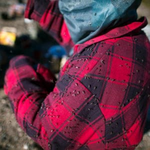 Mosquitoes sit on the jacket of Megan Campbell near the geographic centre of Canada. (Photograph by Nick Iwanyshyn)
