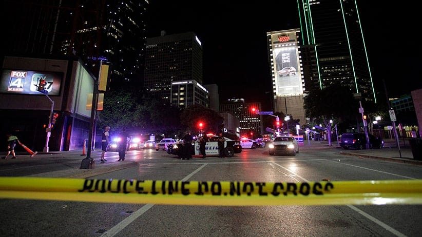 Dallas police officers face protesters on the corner of on the corner of Ross Avenue and Griffin Street after eleven police officers were shot during a peaceful protest in Dallas, Texas, USA, 08 July 2016. Police report that five officers have died as a result of their injuries as it appeared that two snipers shot the police from elevated positions during a protest rally in Dallas on 07 July.  (Ralph Lauer/EPA/CP)